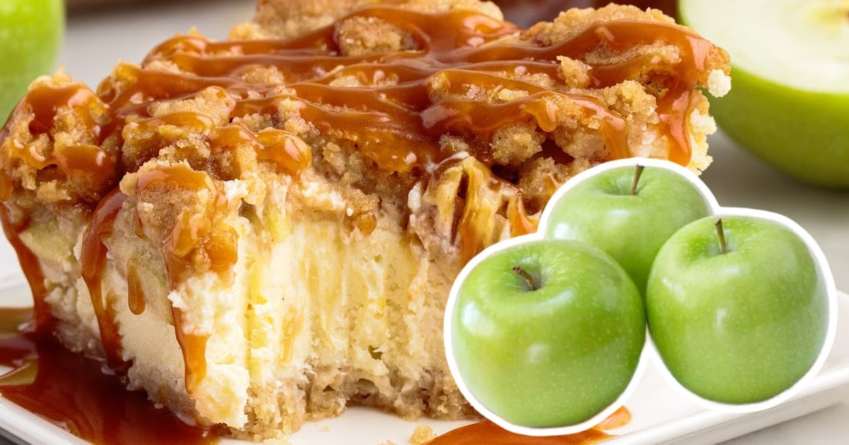 An Apple Cheesecake Bar on a plate, with three apples on the side