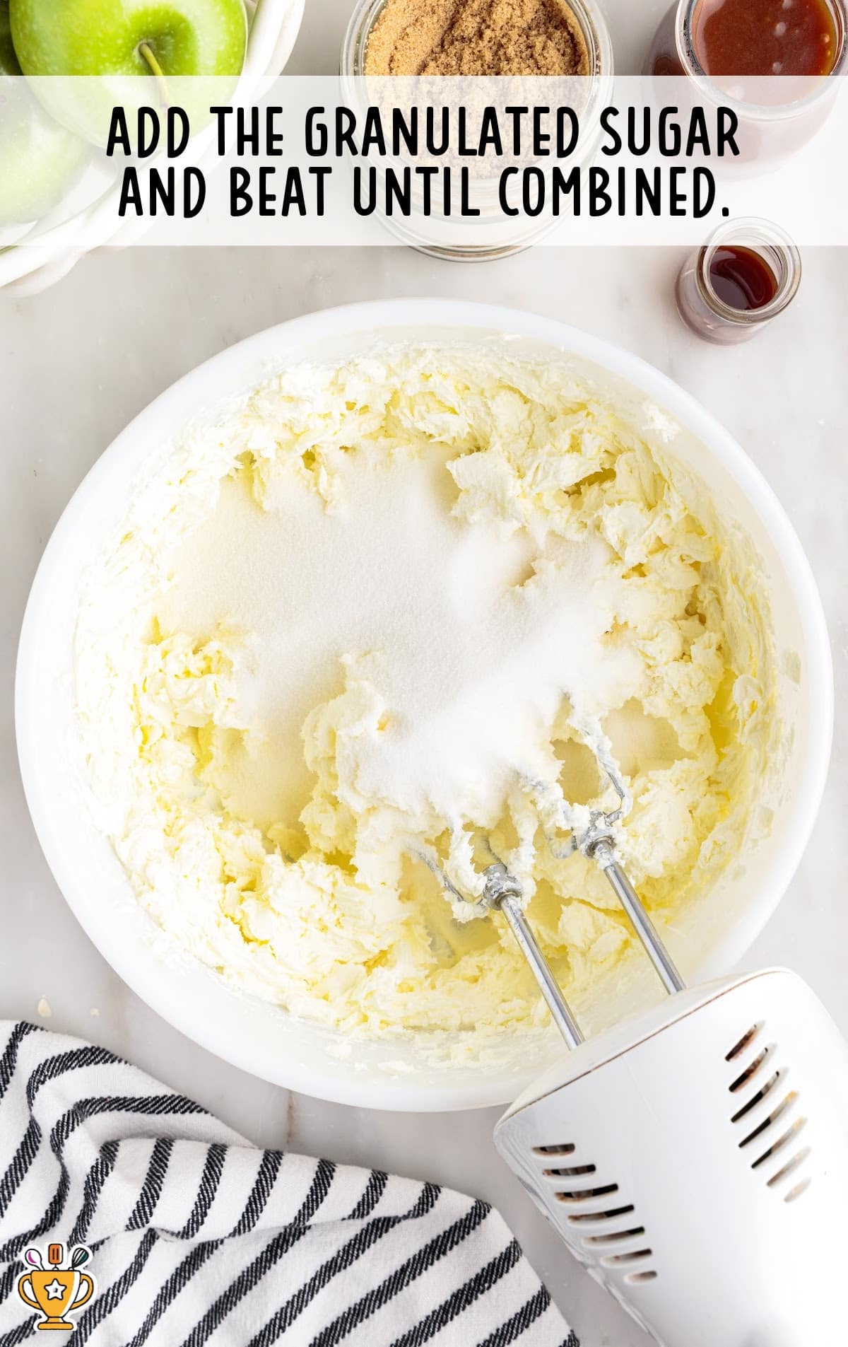 cream cheese and granulated sugar in a bowl with a mixer