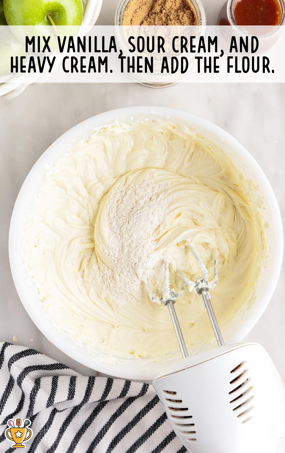vanilla, sour cream, heavy cream and flour in a bowl with a mixer