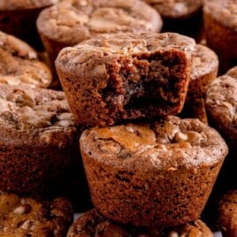 An up close photo of a bunch of Brownie Bites, one with a bite