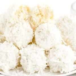 Coconut Snowballs stacked together on a plate