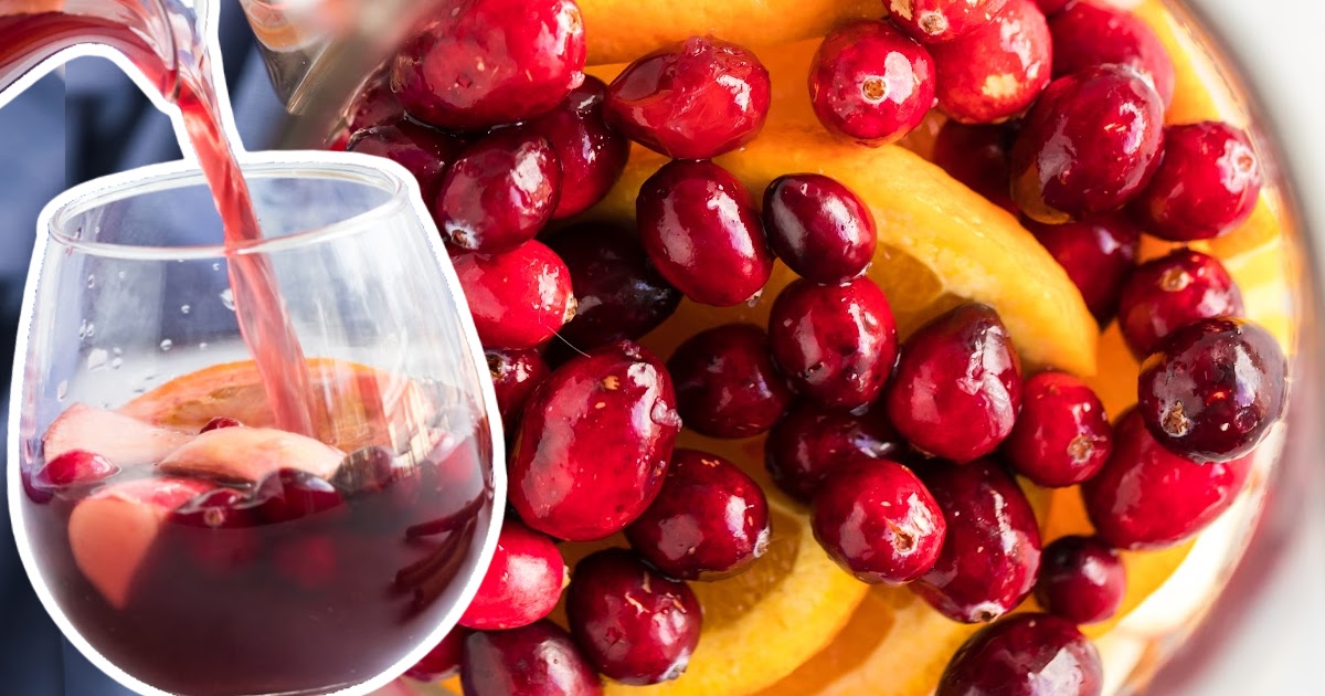 A glass of Fall Sangria and some cranberries on the side