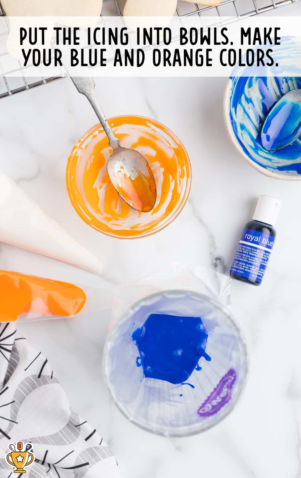 blue and orange icing in two clear bowls
