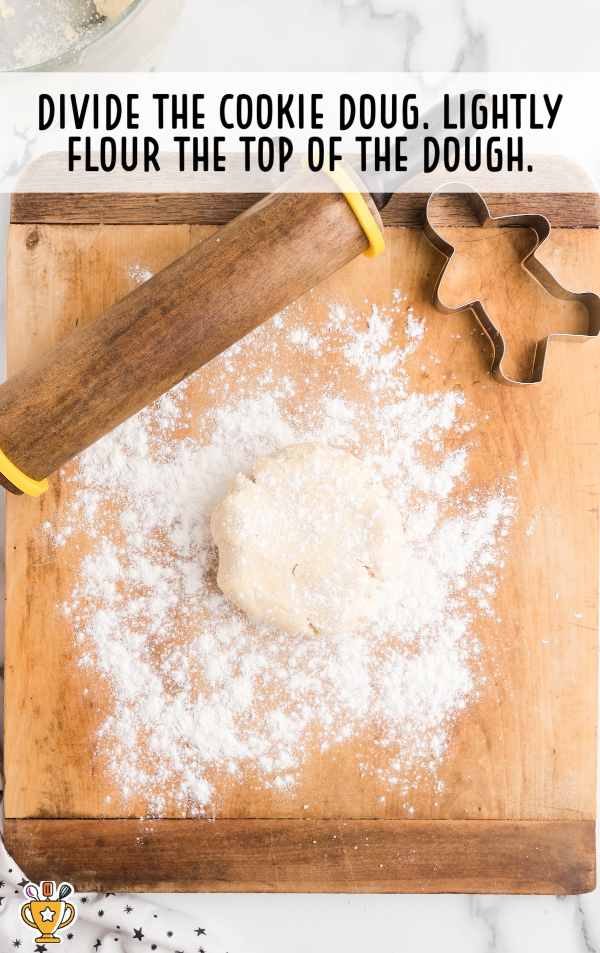 Cookie dough on a wooden board with a cookie cutter