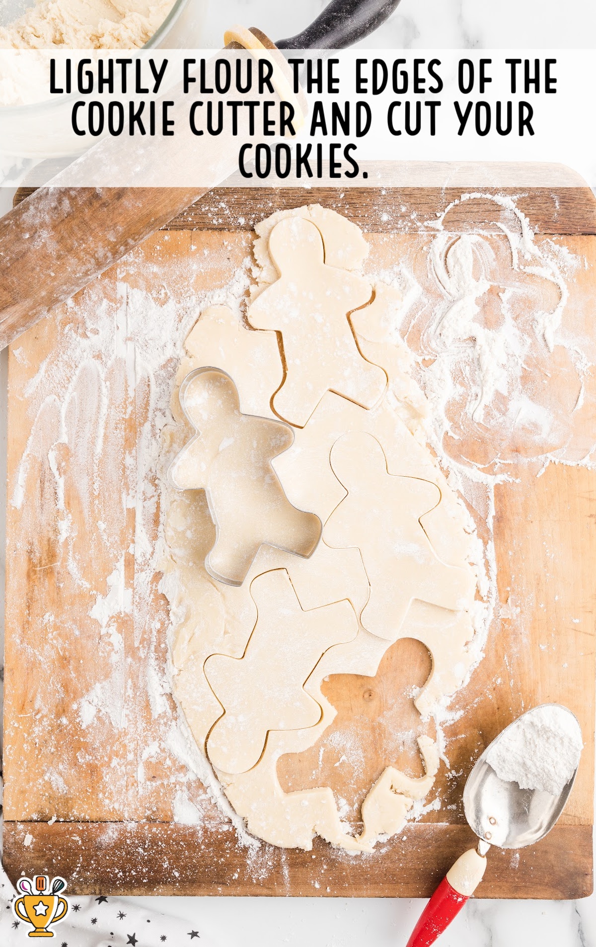 Cookie dough on a wooden board with a cookie cutter