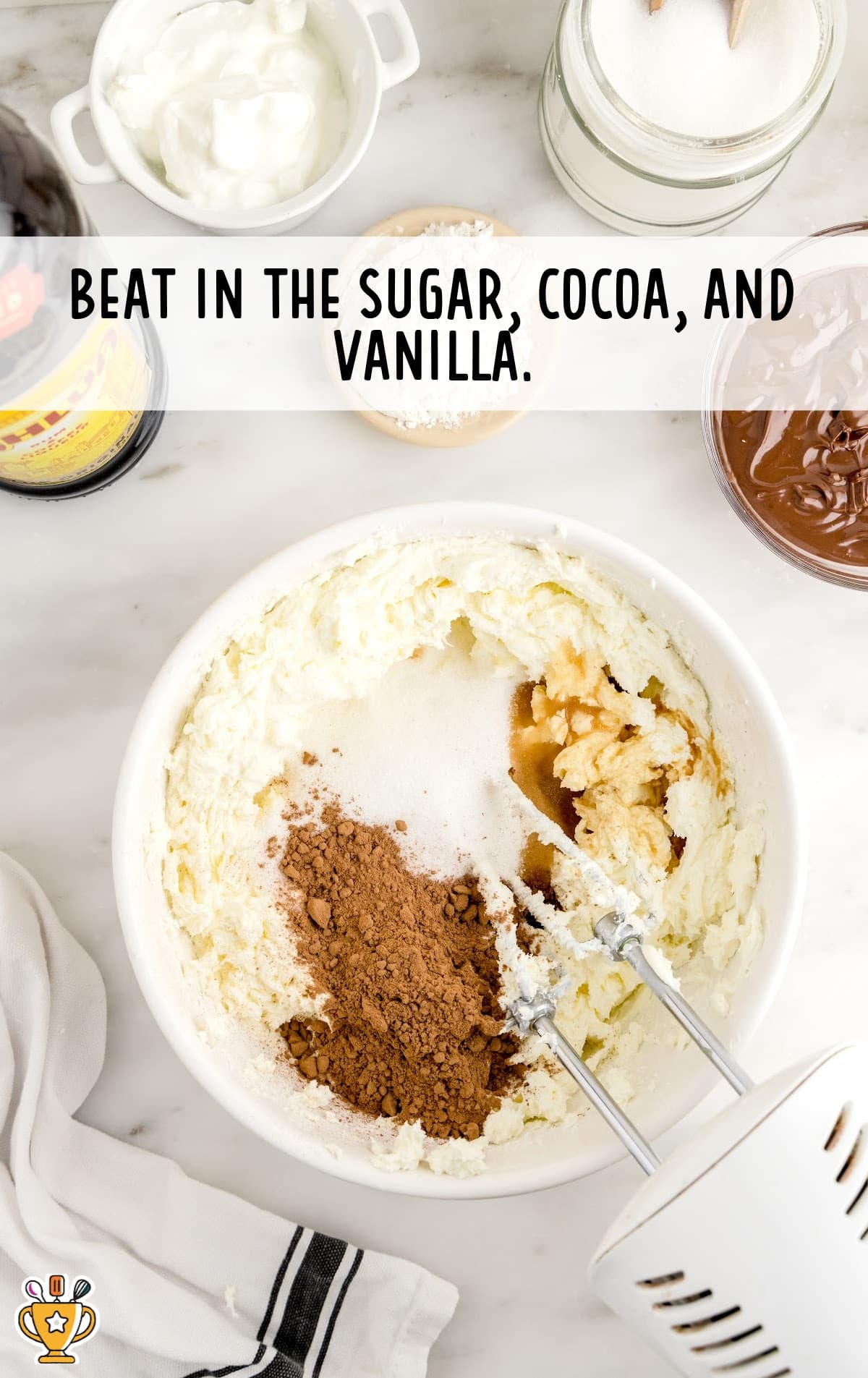 sugar, cocoa and vanilla in a bowl with a mixer