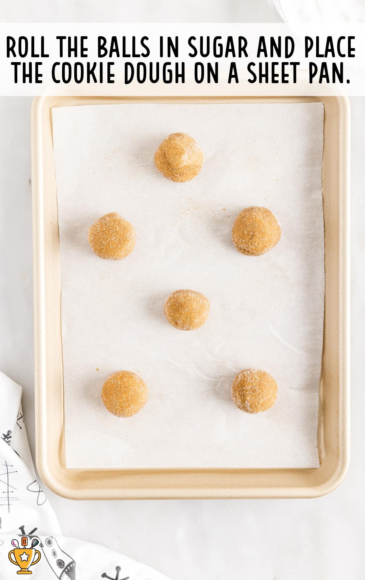 balls rolled in sugar and placed on the sheet pan
