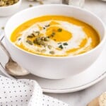 Pumpkin Soup in a bowl with a spoon on the side