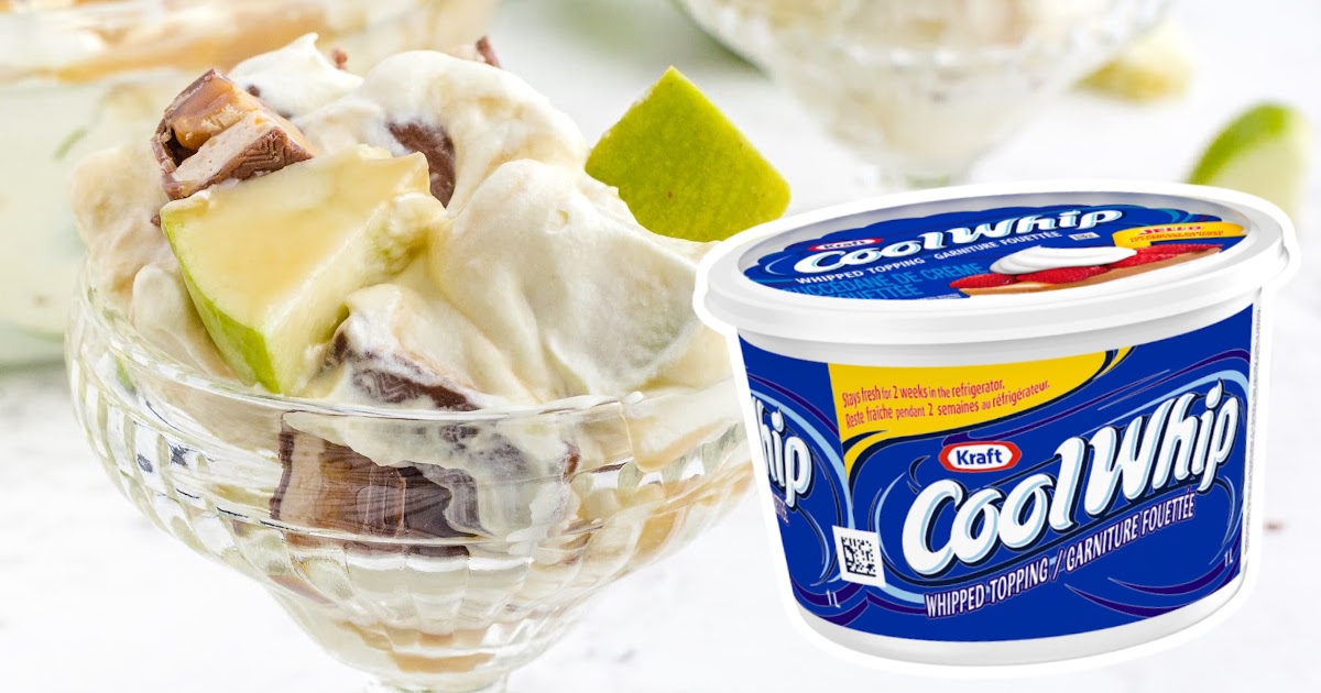 Snickers Salad in a glass with a plastic container of cool whip