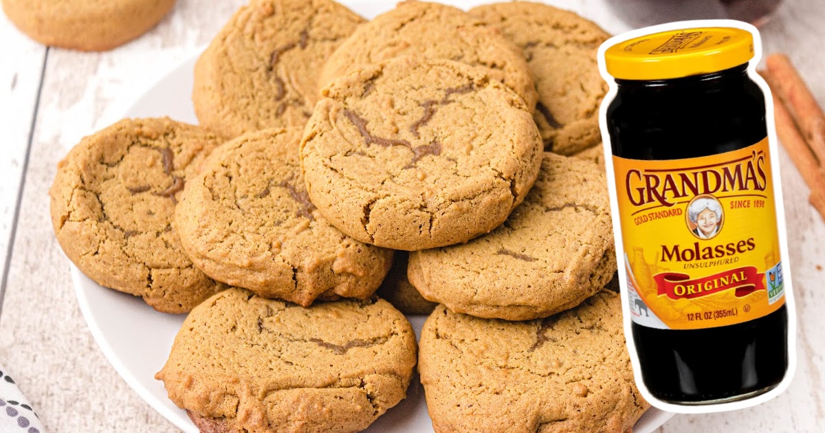 Soft Gingerbread Cookies on a plate with a jar of molasses on the side