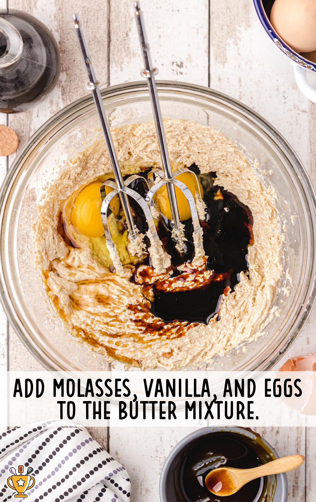 molasses, vanilla and eggs added in a bowl of butter mixture with a food mixer in the bowl