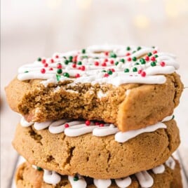 Soft Gingerbread Cookies stacked together the top one with a bite on it