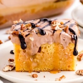 A piece of Turtle Poke Cake on a plate