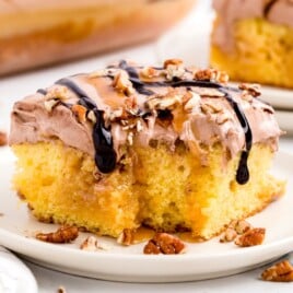 A piece of Turtle Poke Cake on a plate