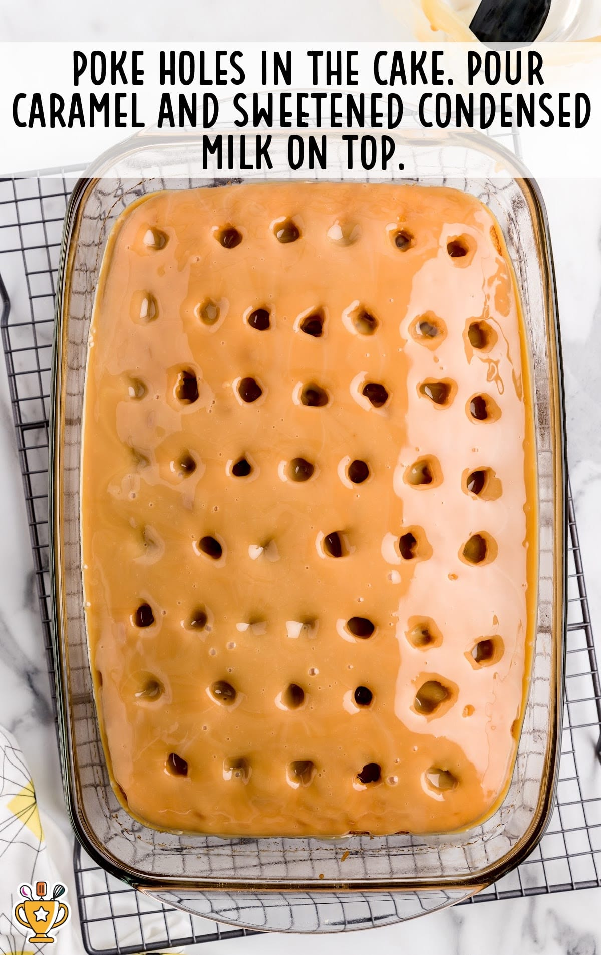A Turtle Poke Cake with poked holes, in a baking dish