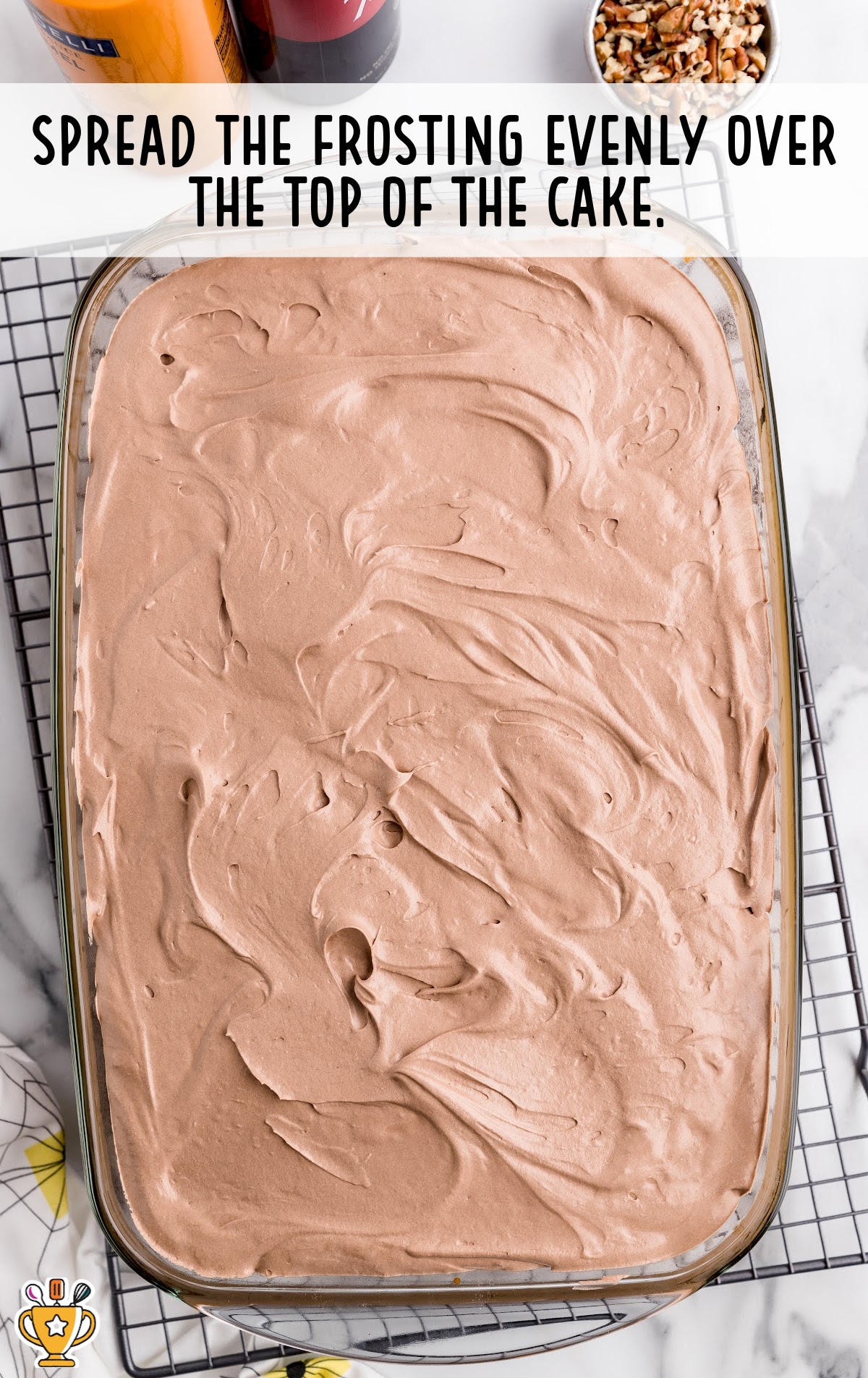 Frosting spread over the top of cake