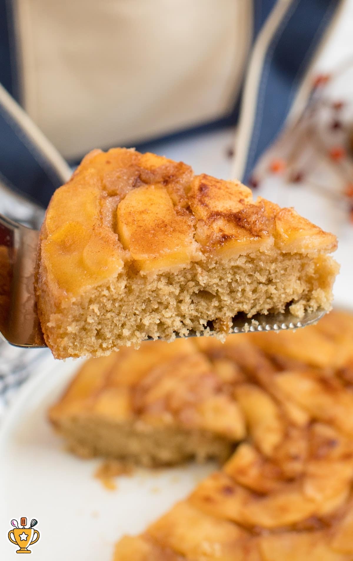 A piece of Apple Upside Down Cake held by a spatula