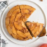 Apple Upside Down Cake on a plate with a piece missing