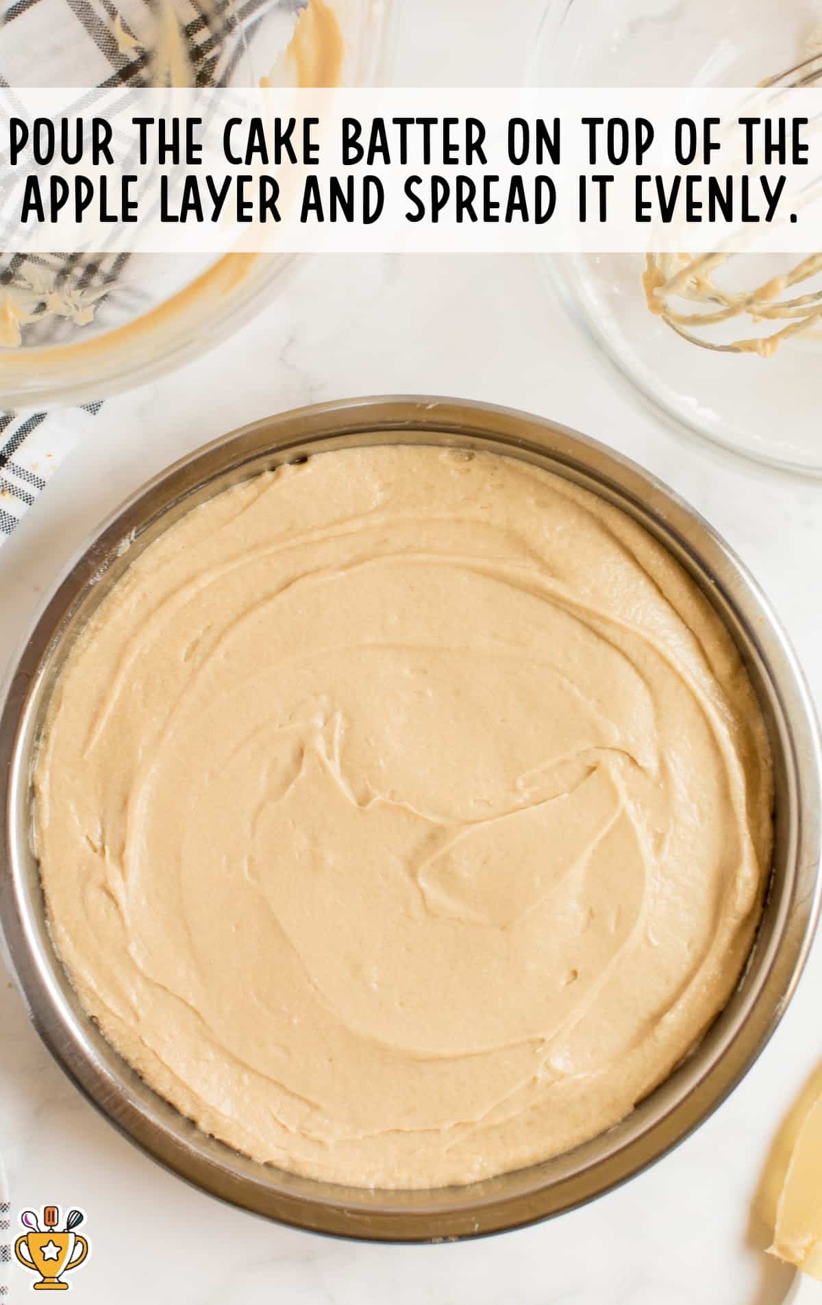 cake batter poured on top of apple layer