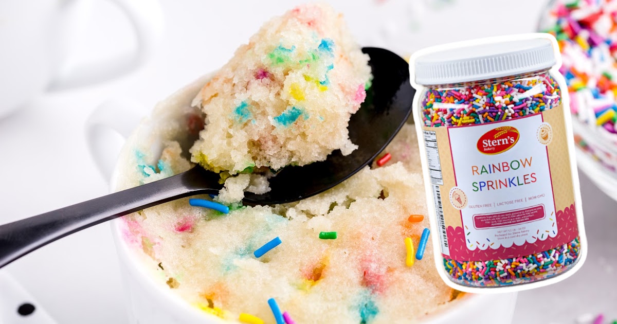Vanilla Mug Cake in a mug, with a spoon scooping some cake
