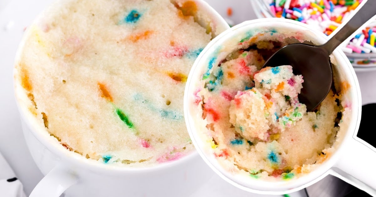 A mug full of Vanilla Mug Cake with a spoon in it