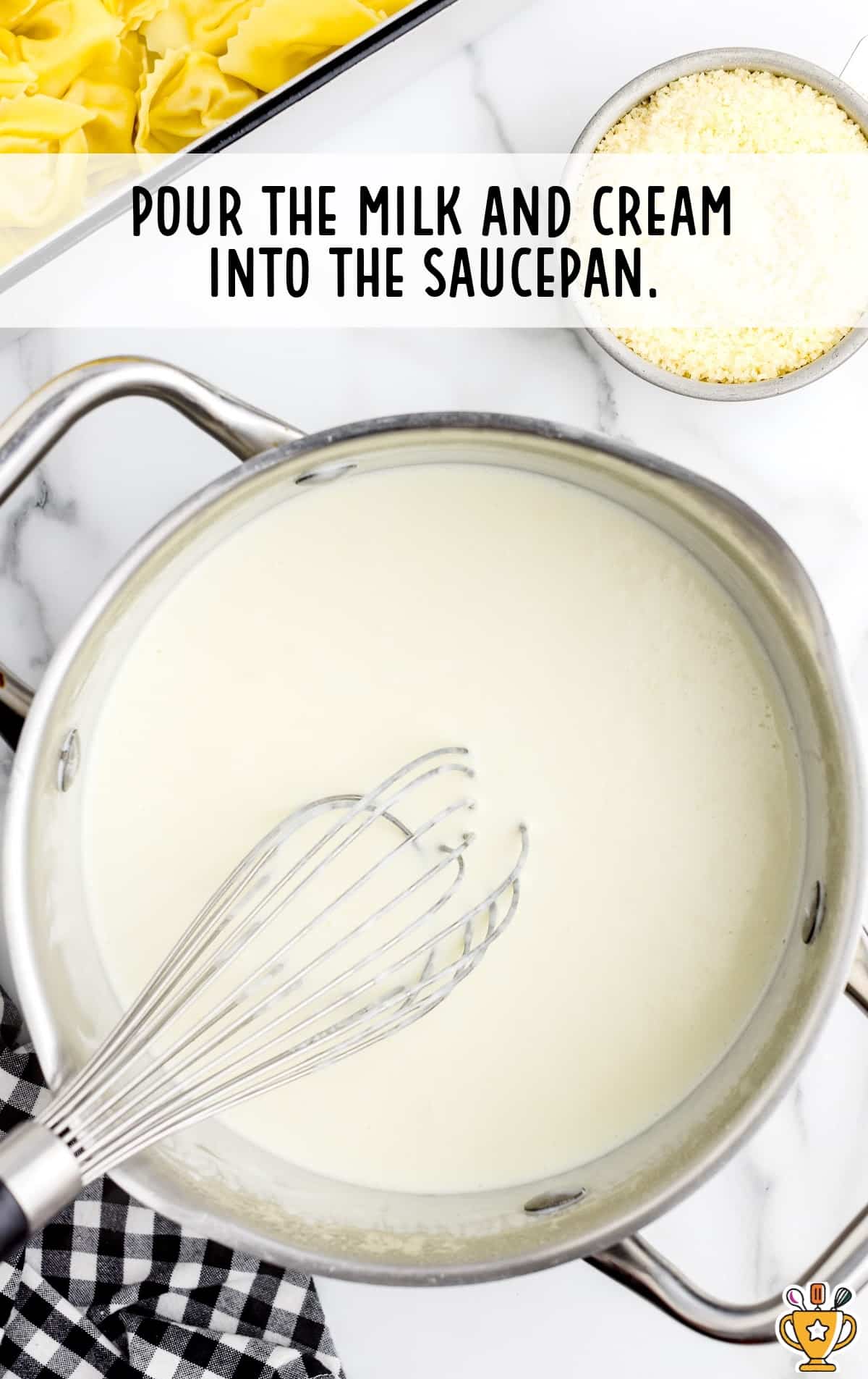 Milk and cream in a saucepan mixed together with a whisker