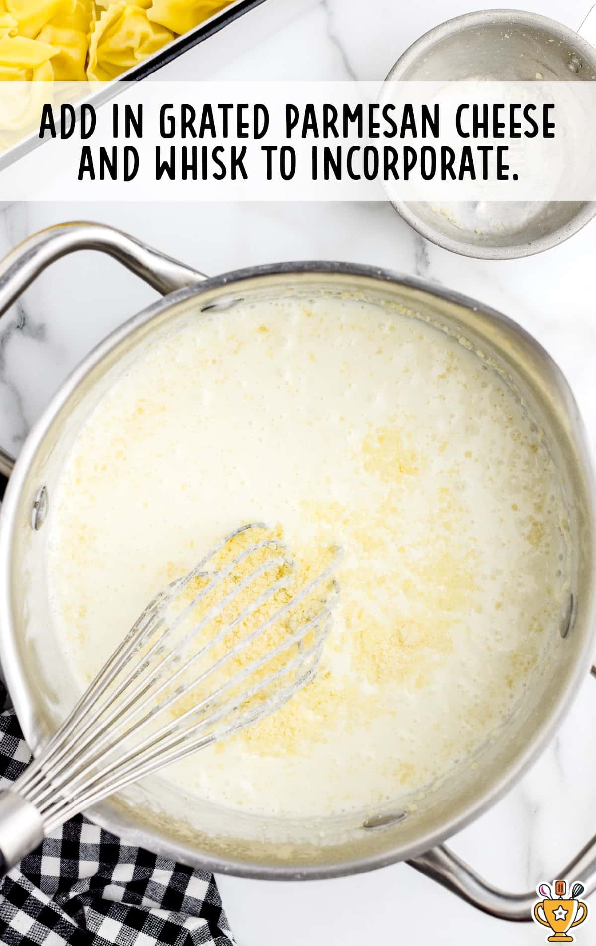 Grated parmesan cheese whisked in a saucepan