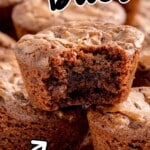 A Brownie bite with a bite on it and a bunch of ither Brownie Bites