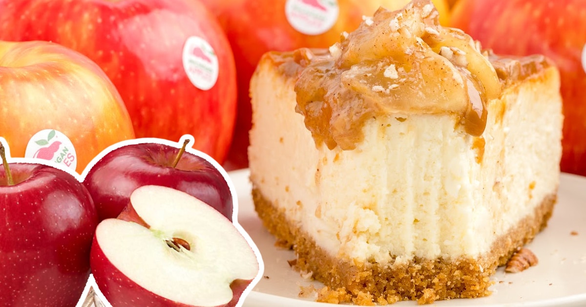 a slice of caramel cheesecake with an apple topping beside a bunch of apples