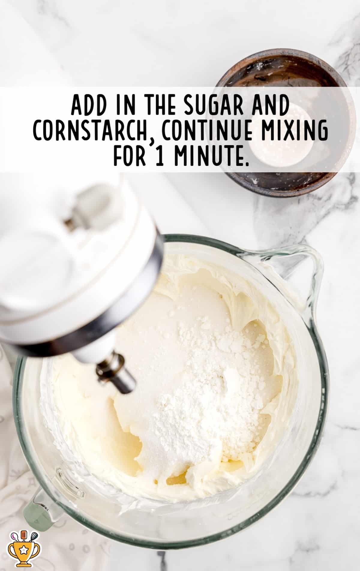 sugar and corn starch added in the mixture in a bowl