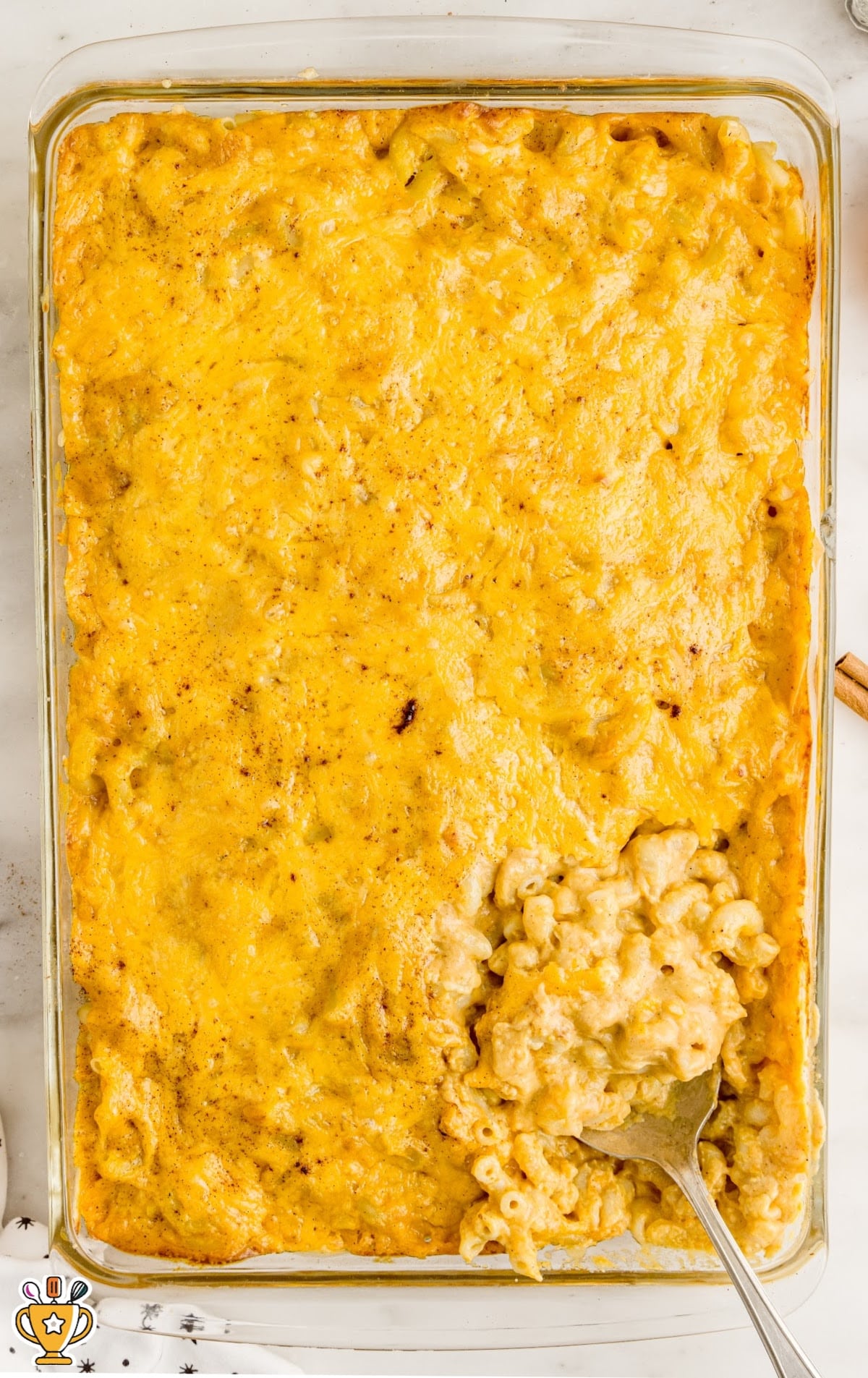 Pumpkin Mac and Cheese in a glass baking dish with a fork in it