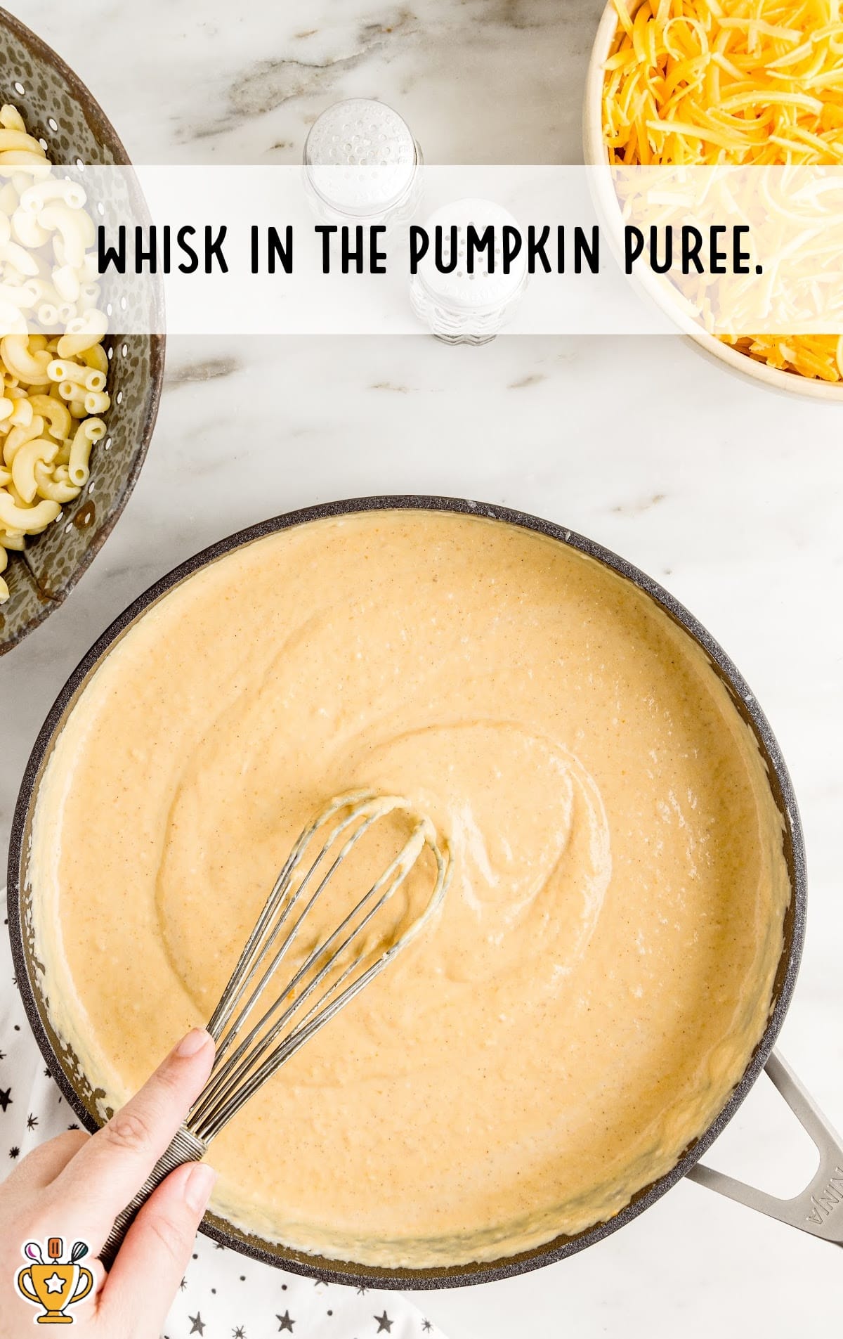 Pumpkin puree in a pan with a whisker in it