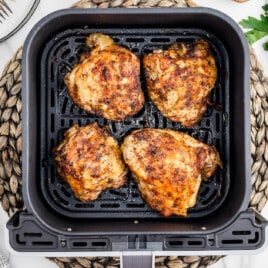 Air Fryer Chicken Thighs inside an air fryer basket