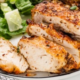 Air Fryer Chicken Thighs on a plate, sliced.