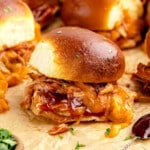 bbq chicken sliders of a wood board.