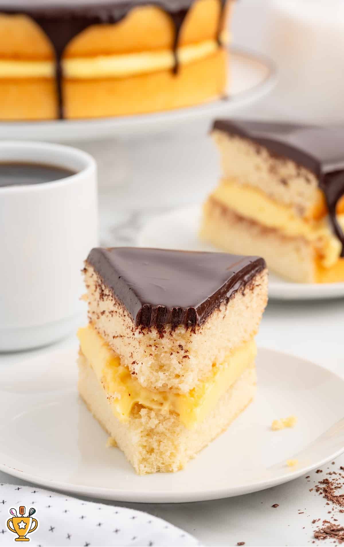 A piece of Boston Cream Pie on a small desert plate