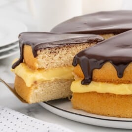 Boston Cream Pie with a piece being taken out