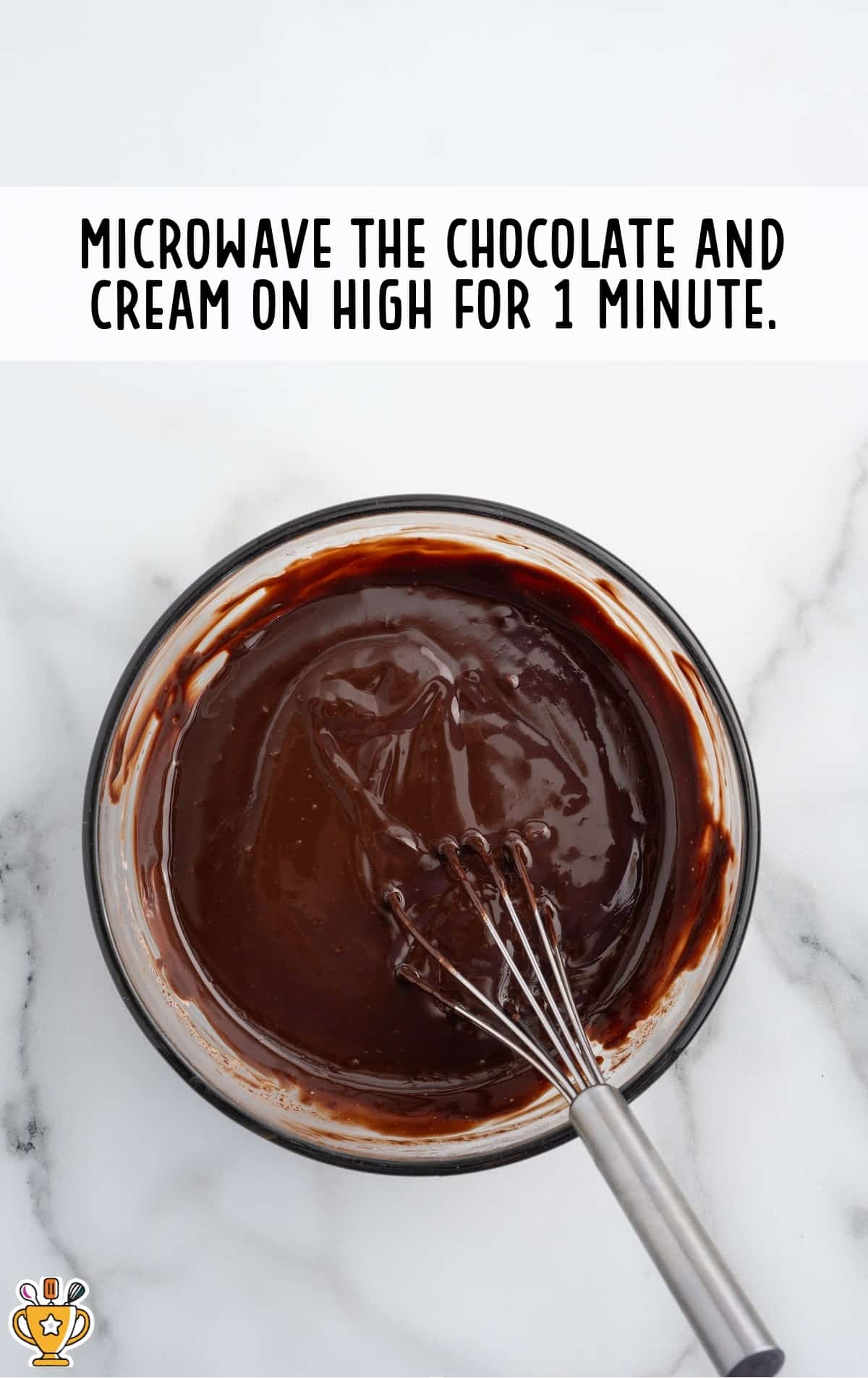 microwaved chocolate and cream in a bowl with a whisker