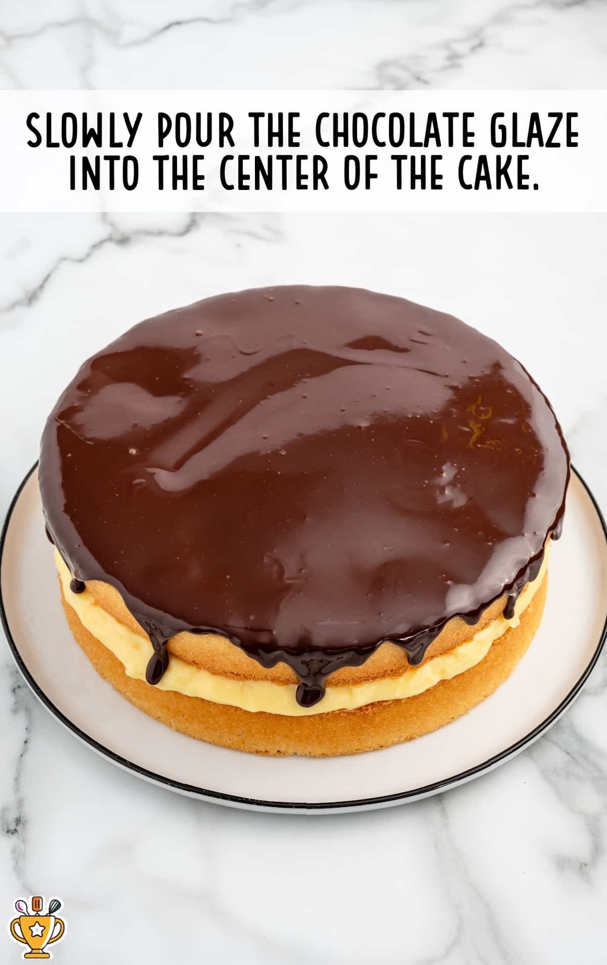Chocolate glaze poured on top of aBoston Cream Pie