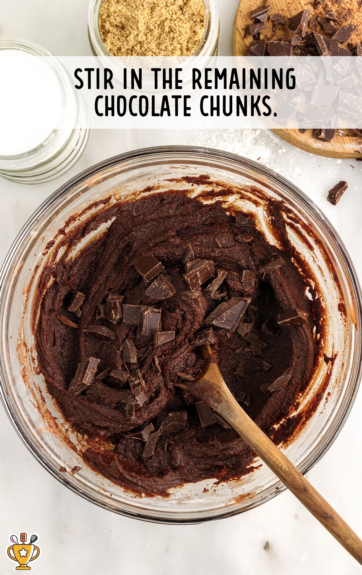 A bowl of brownie batter with the chocolate chunks mixed in.