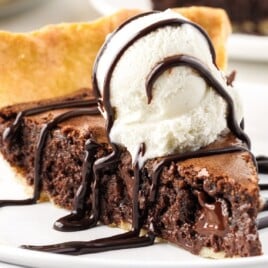 A piece of Brownie Pie on a stack of plates
