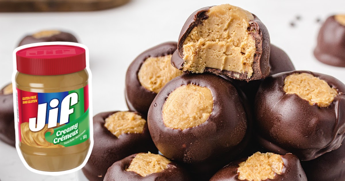 A stack of Buckeyes with a jar of peanut butter on the side