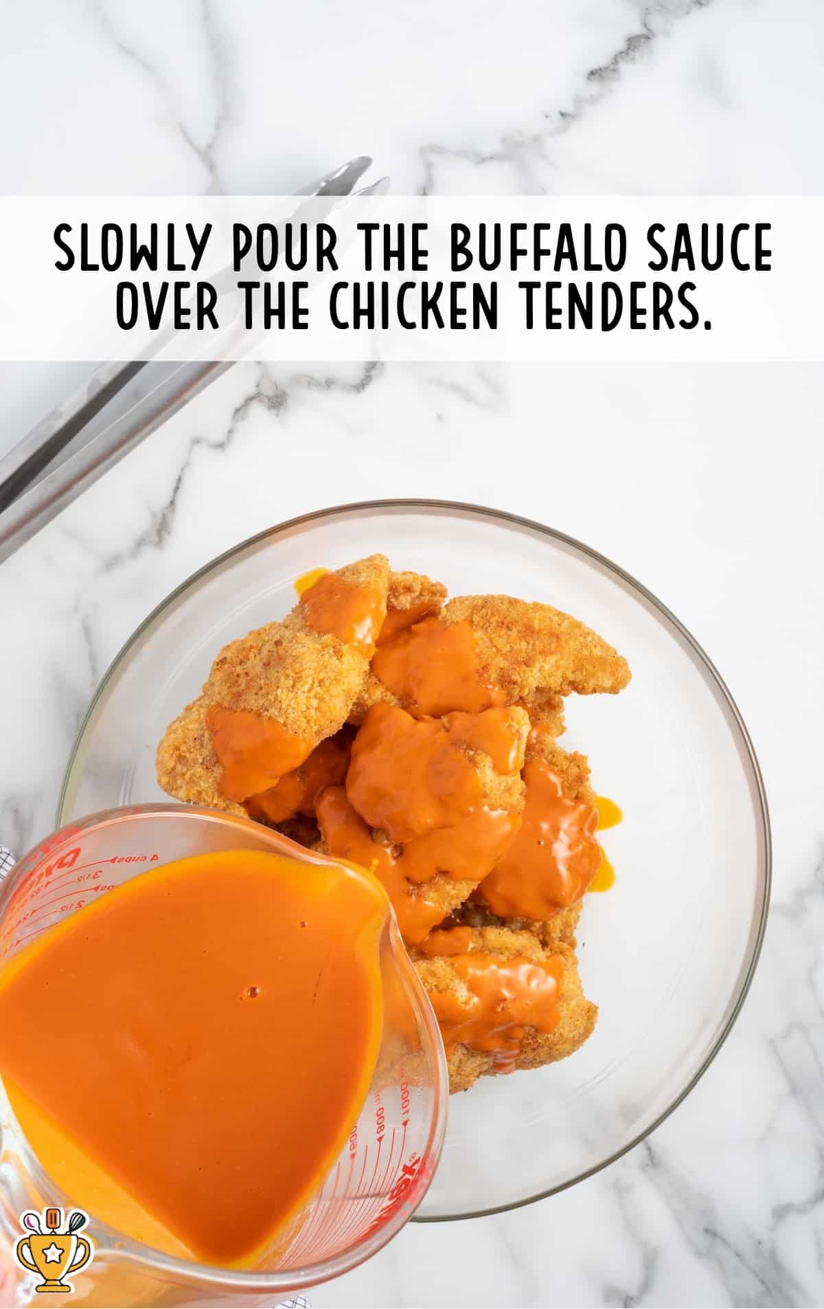 buffalo sauce poured in a bowl of chicken tenders