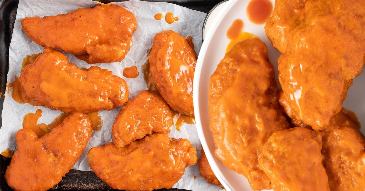Buffalo Chicken Tenders on a plate and on a serving platter