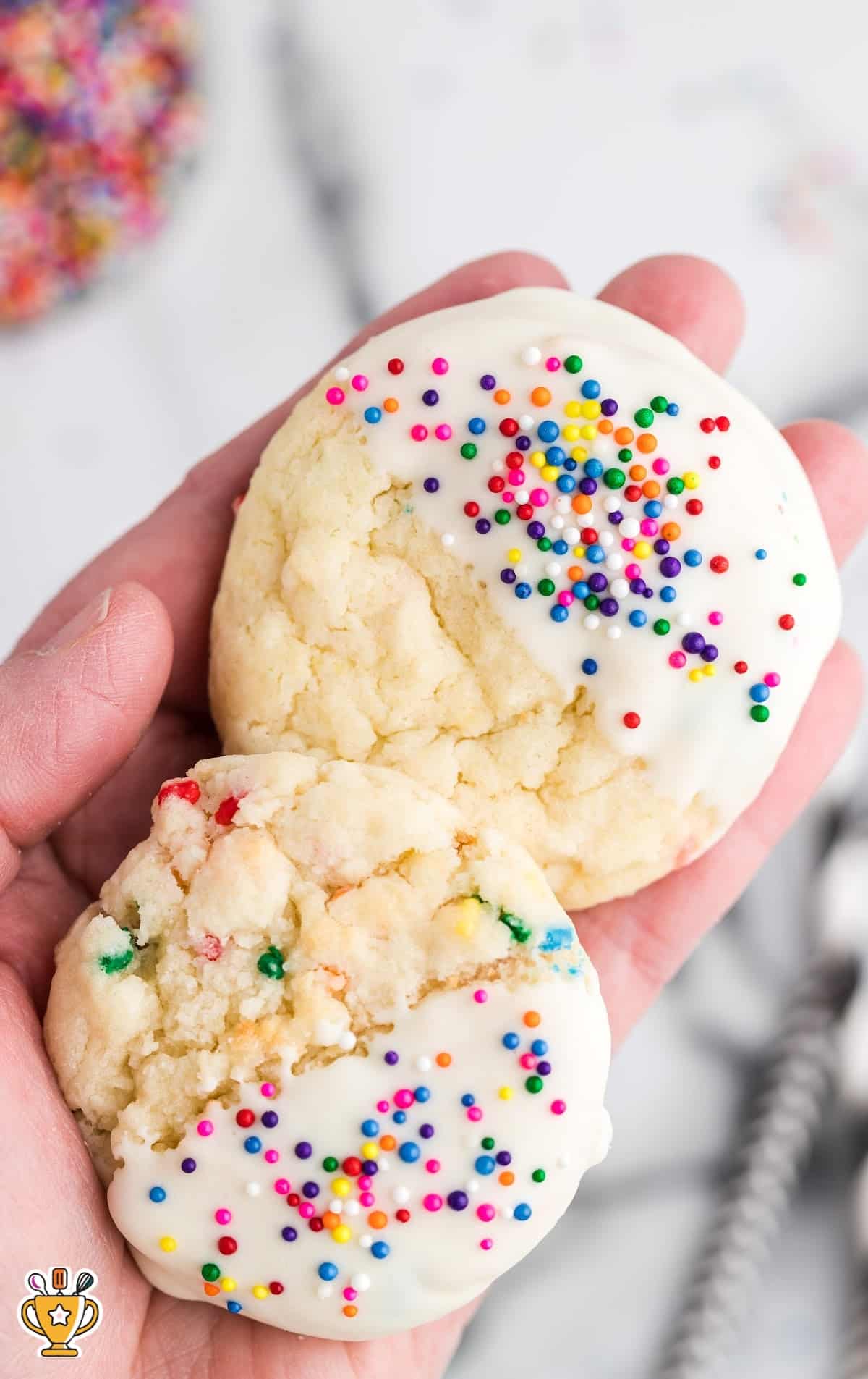 a hand holding two Cake Mix Cookies