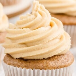 a big swirl of caramel icing on a cupcake