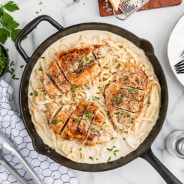 A skillet full of chicken alfredo recipe.