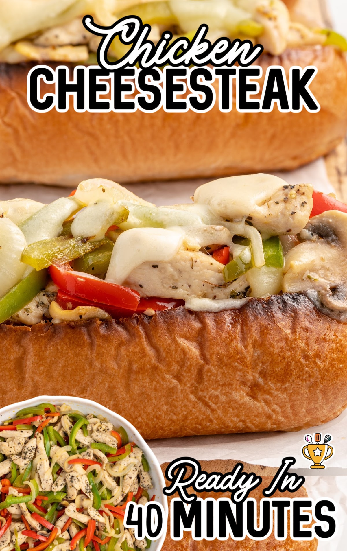 A few chicken cheesesteak sandwiches on a cutting board.