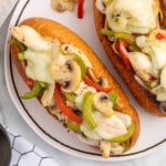 Chicken Cheesesteak sandwiches on a white plate.