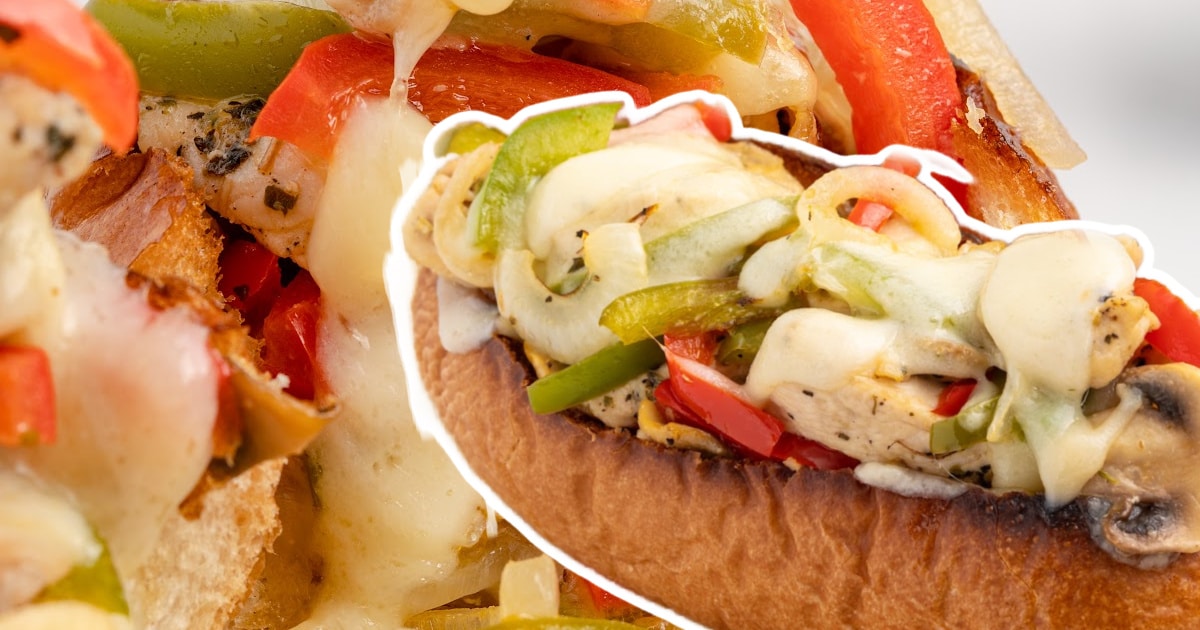 A Chicken Cheesesteak with plenty of filling and melted cheese.